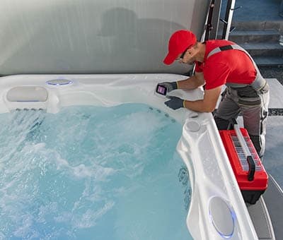hot tub professional working on hot tub maintenance